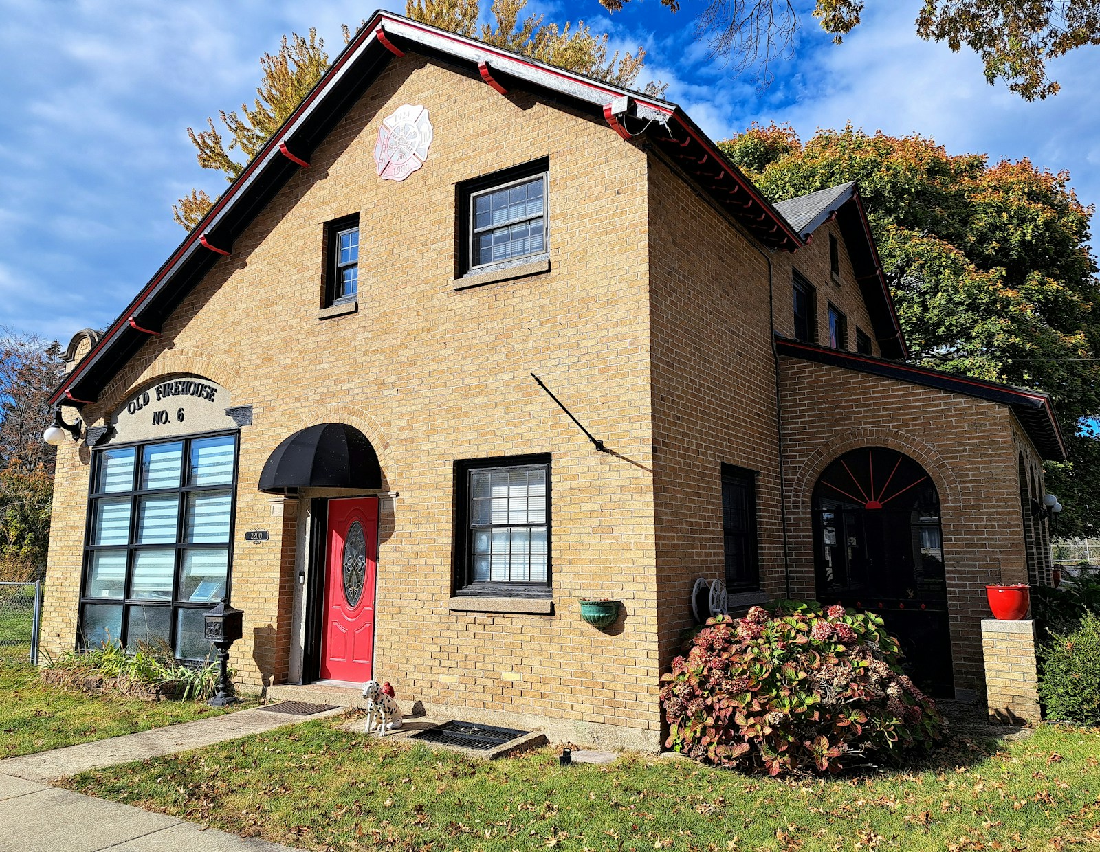 Charming brick home with a red door representing a well-priced Grand Rapids MI listing in 2026